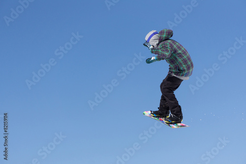 Snowboarder jumps in Snow Park