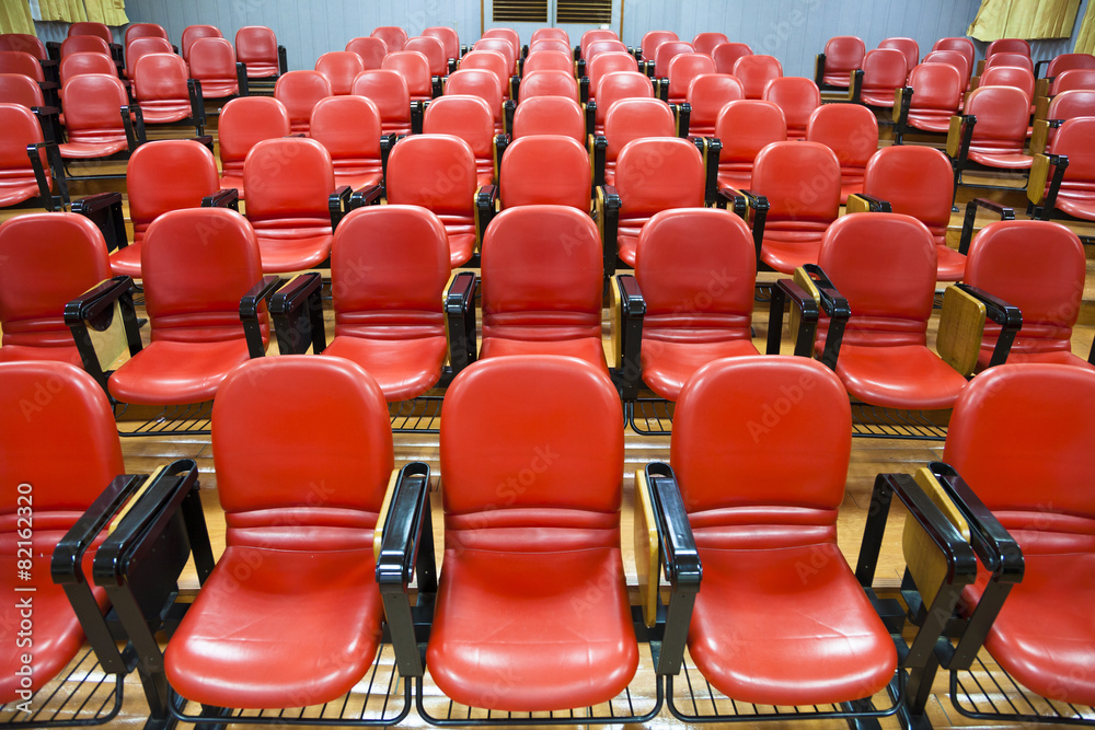 Interior of empty conference hall with red chairs