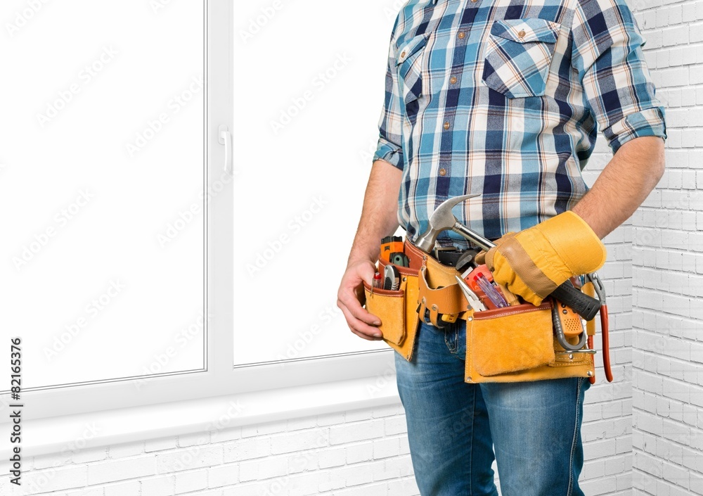 White. Worker with a tool belt. Isolated over white background. White. Worker with a tool belt. Isolated over white background.