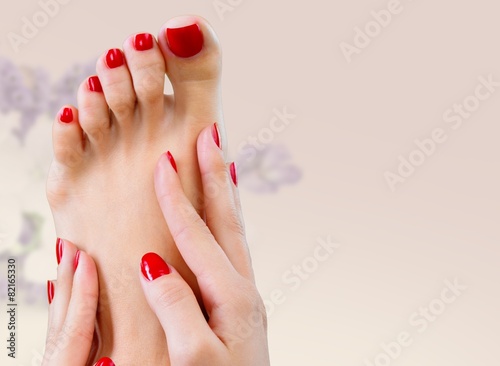 Spa. Closeup photo of a female feet with beautiful red pedicure