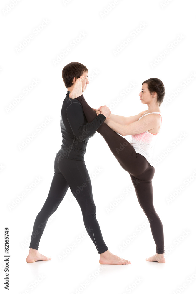 Extended hand-to-big-toe pose with coach
