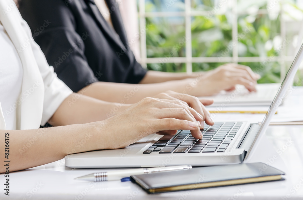 two business workers typing data in laptop two business workers typing data in laptop