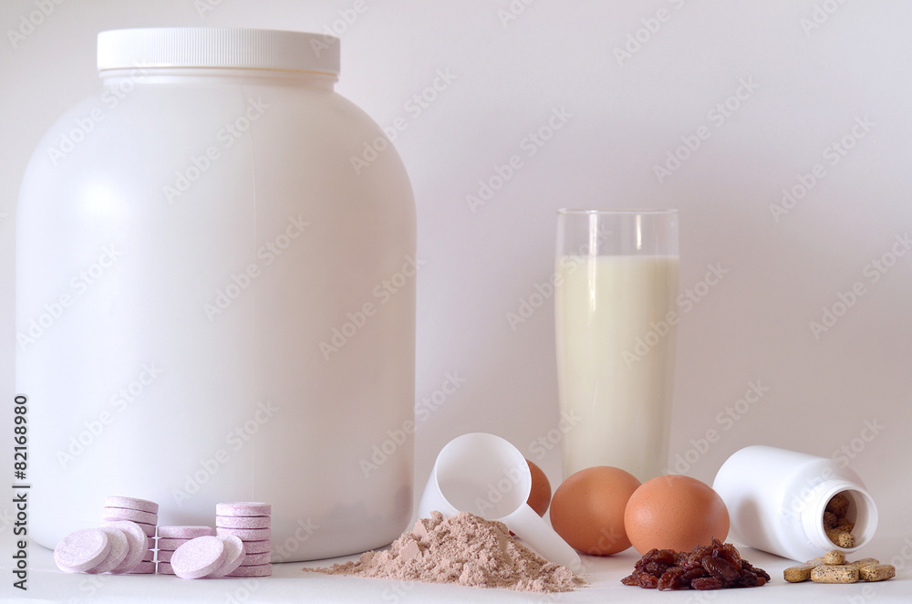Big jar of protein powder, shaker, milk, pills and tablets Big jar of protein powder, shaker, milk, pills and tablets