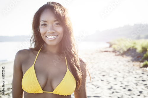 Mixed race woman in bikini on beach