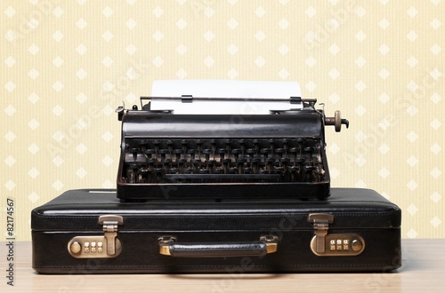 Antique. Typewriter and vintage suitcase