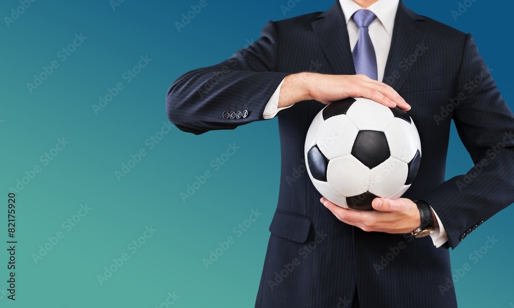 Soccer. Elegant businessman holding a soccer ball, close up Soccer. Elegant businessman holding a soccer ball, close up
