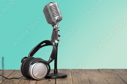 Aquamarine. Retro microphone and headphones on table