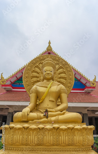 the khmer style gold buddha statue sitting under sunlight