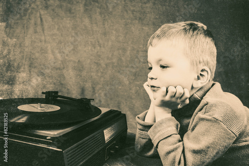 boy listening to retro music player photo
