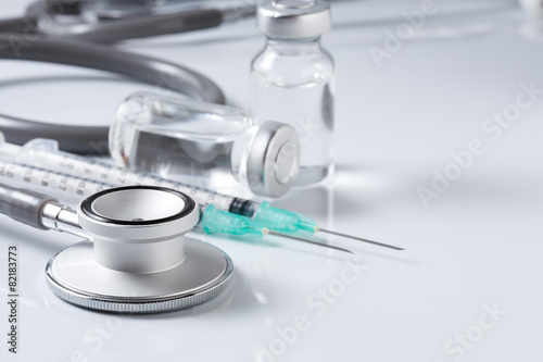 Medical equipment : stethoscope ampules and syringe on white ba