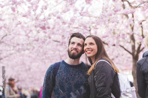 Canvas Print Hipster couple portrait in Stockholm with cherry blossoms