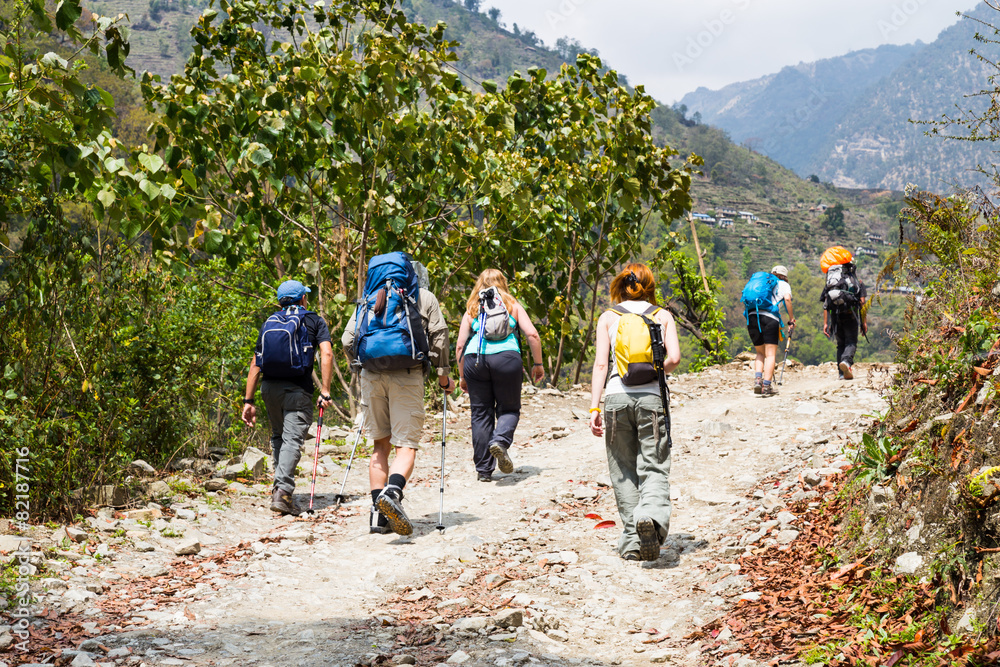 A group of people trekking on dirt road in Nepal