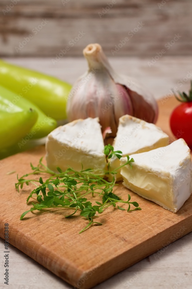 Cress shoots in front of camembert portions