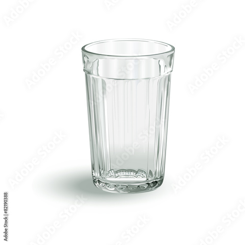 one transparent empty faceted glass on a white background