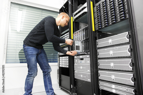 IT engineer installs blade server in datacenter