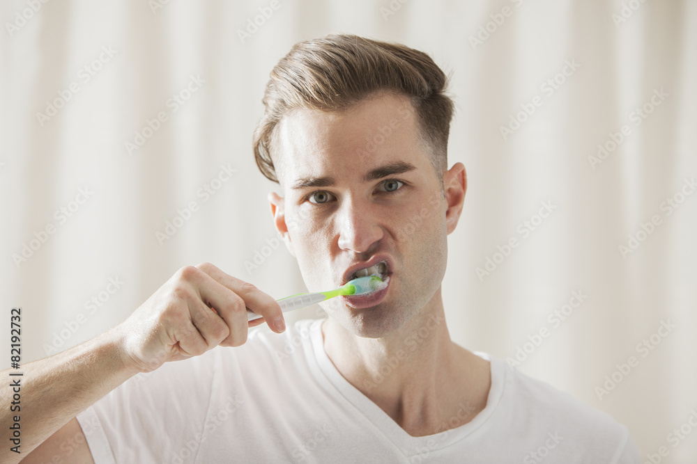 Caucasian man brushing his teeth Caucasian man brushing his teeth