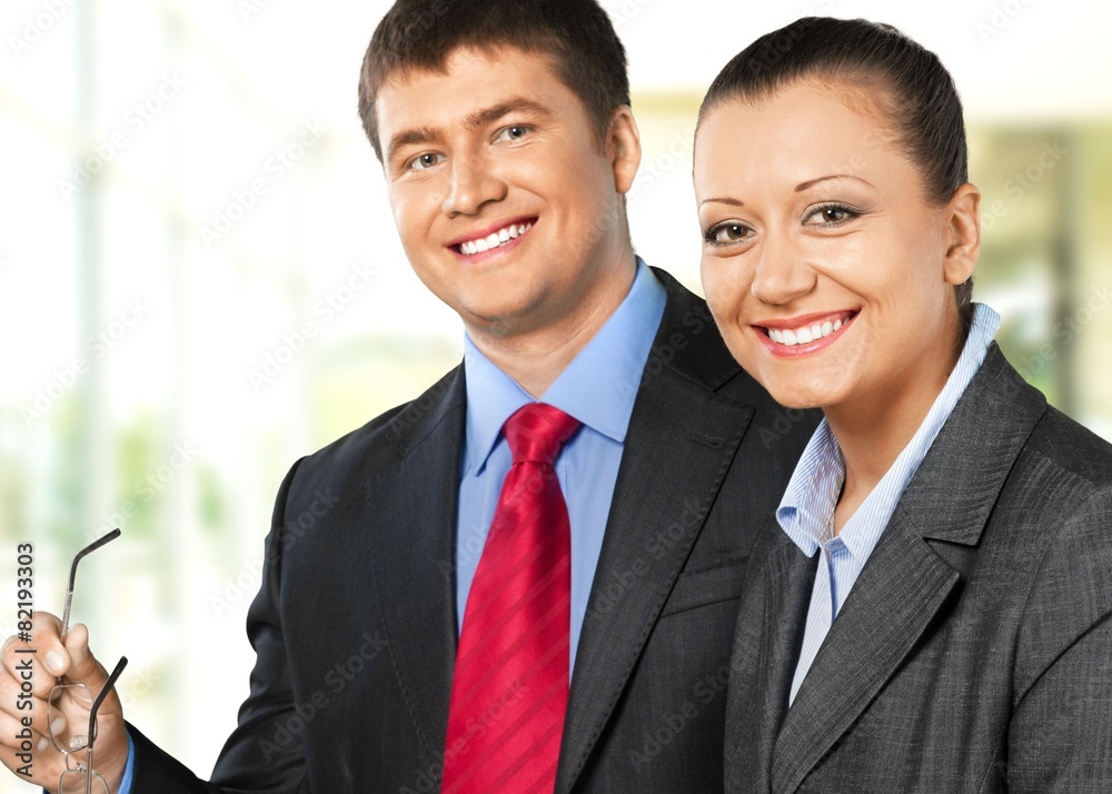 Business. Businesswoman smiling with a businessman Business. Businesswoman smiling with a businessman