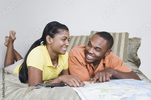Multi-ethnic couple looking at map photo