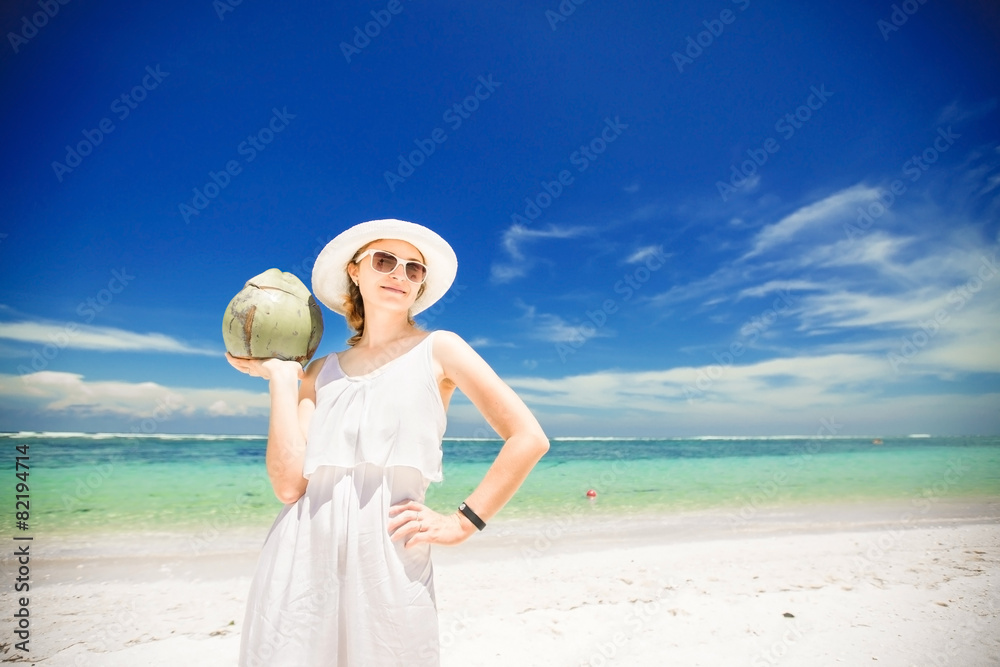 Beautiful young woman holding and drinkind a coconut fresh Beautiful young woman holding and drinkind a coconut fresh