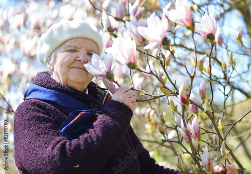 Tableau sur toile Senior woman smiling and dreaming in garden.