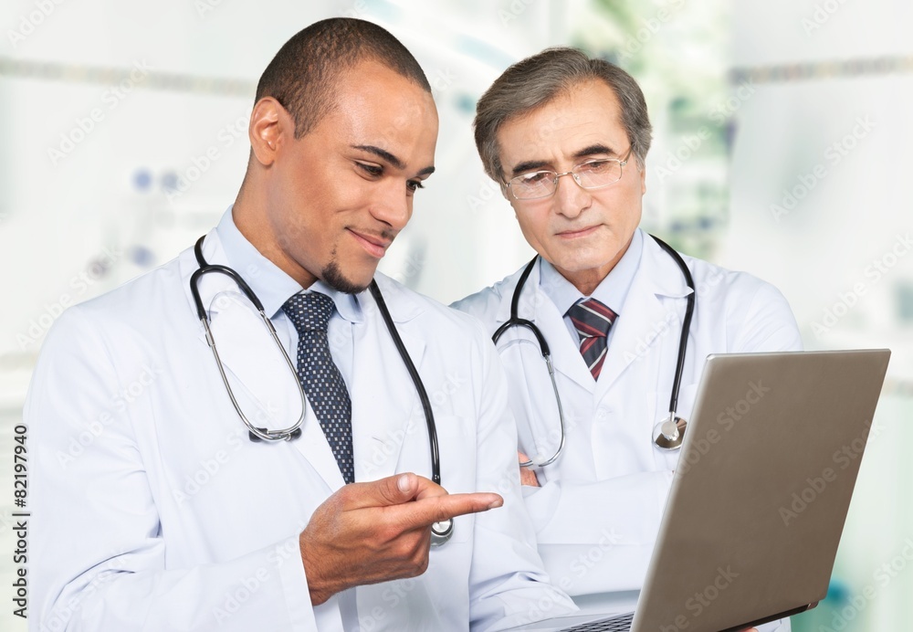 Doctor. Two doctors looking at the laptop. Doctor. Two doctors looking at the laptop.