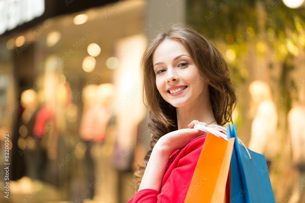 Young. Lovely woman with shopping bags over white Young. Lovely woman with shopping bags over white