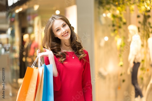 Young. Lovely woman with shopping bags over white