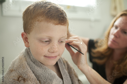 Caucasian mother giving son haircut photo