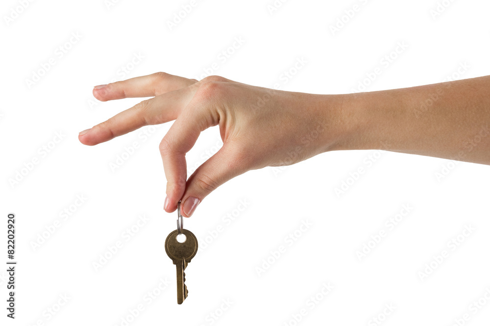 Close up view of hand holding key to a dream house Close up view of hand holding key to a dream house