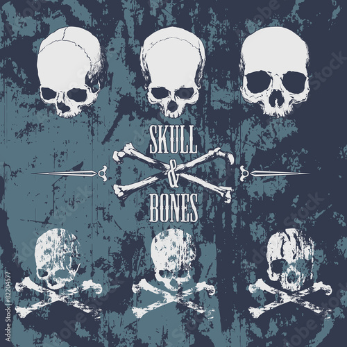 Skulls and cross bones on the grunge background photo