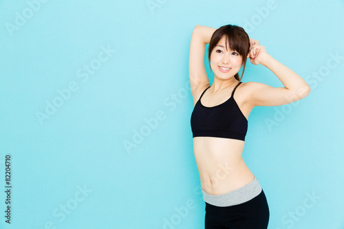 Fototapeta Naklejka Na Ścianę i Meble -  sporty asian woman on blue background