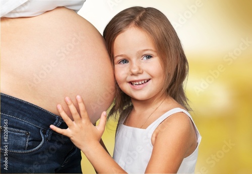 Fotografija Human Pregnancy. Mother pregnant and surprised goggle-eyed child