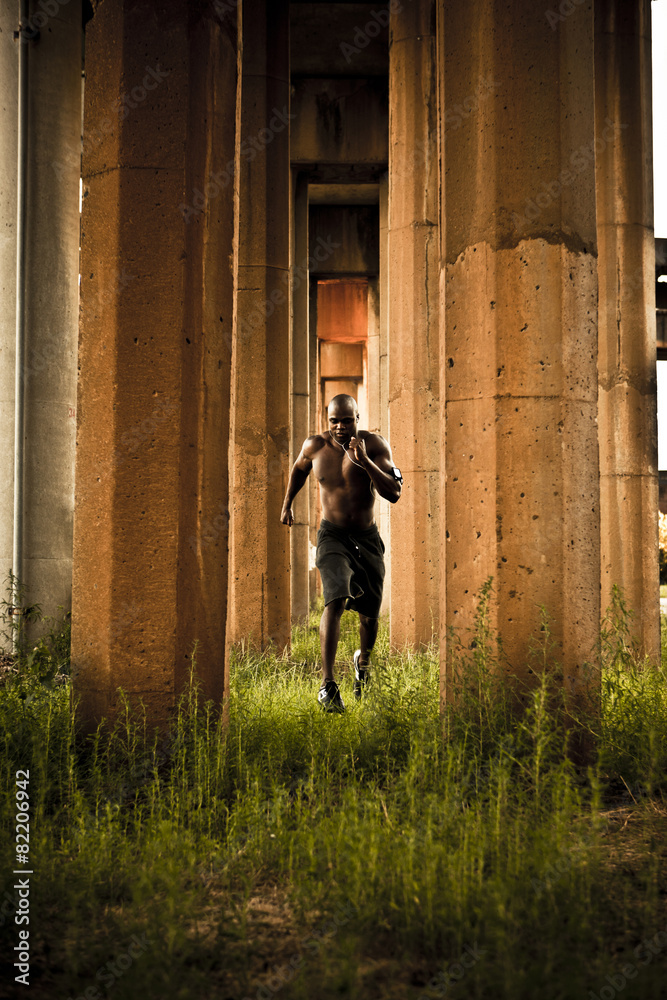 African American man jogging between pillars Stock Photo Adobe Stock