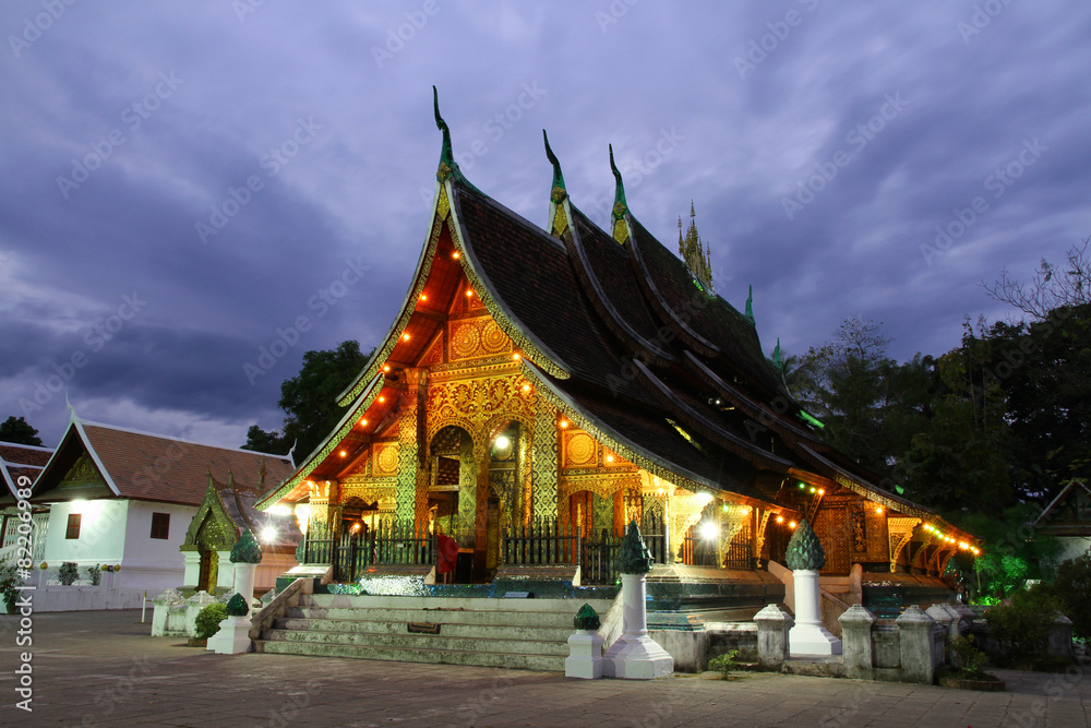 Colorful Wat Xieng thong temple at dusk in Luang Prabang, Loas