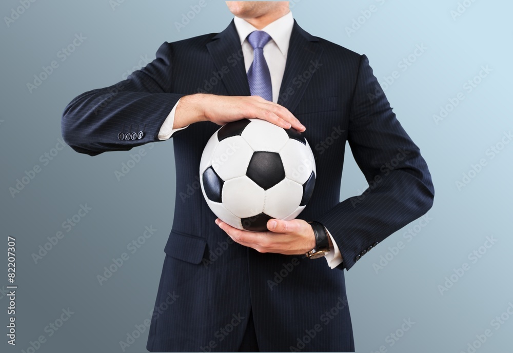 Soccer. Elegant businessman holding a soccer ball, close up Soccer. Elegant businessman holding a soccer ball, close up