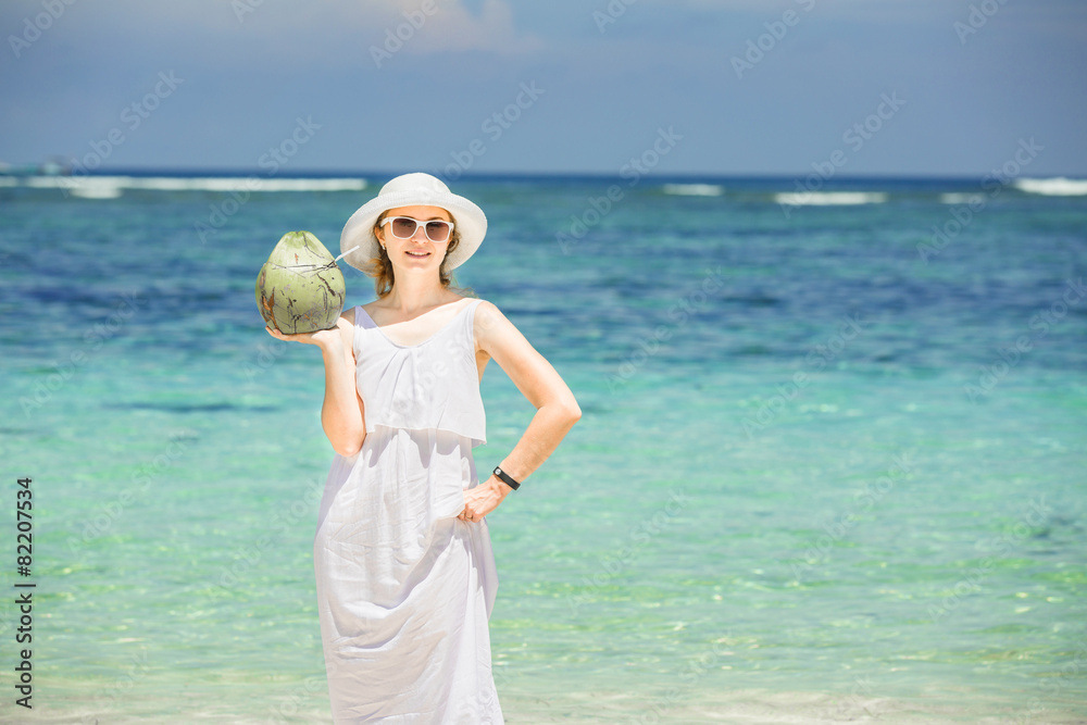 Beautiful young woman holding and drinkind a coconut fresh Beautiful young woman holding and drinkind a coconut fresh
