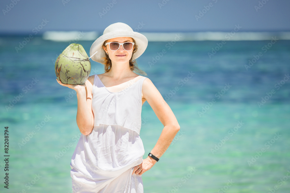 Beautiful young woman holding and drinkind a coconut fresh Beautiful young woman holding and drinkind a coconut fresh