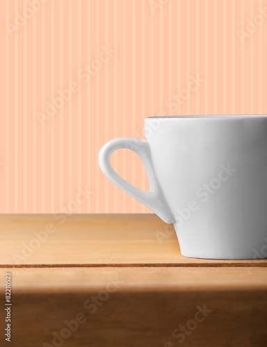 Design. Background with white cup on wooden table over grunge