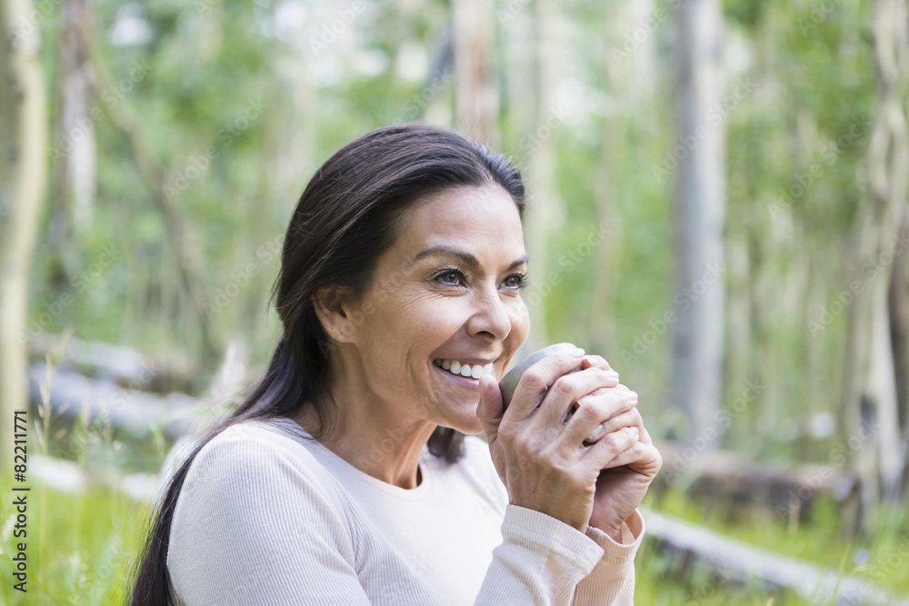 Hispanic woman having cup of coffee outdoors Hispanic woman having cup of coffee outdoors