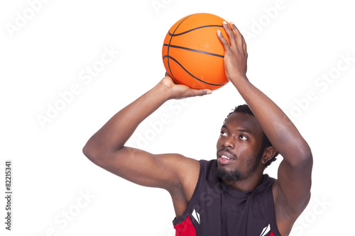 Basketball player launching the ball, isolated on white backgrou