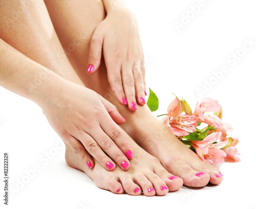 Beautiful female legs with flowers, isolated on white background © Africa Studio