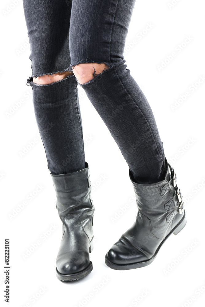 Girlish legs in torn jeans isolated on white Girlish legs in torn jeans isolated on white