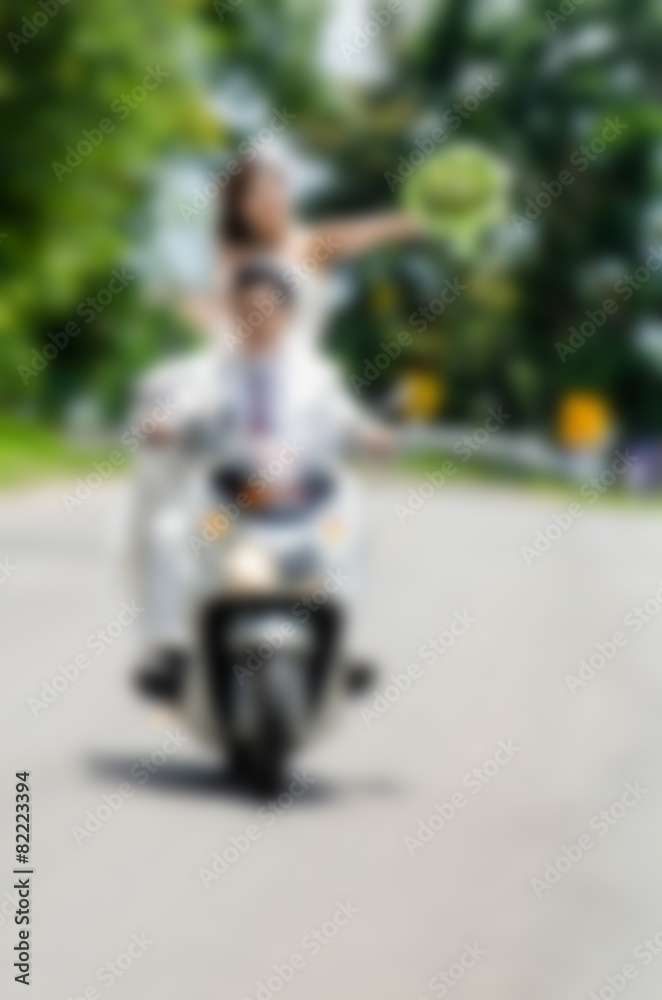 Blurry Just married. Groom and bride on the motorcycle