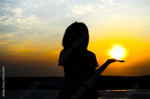 Young girl enjoying beautiful sun rise.