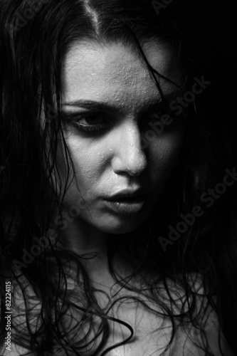 Wet woman portrait with water drops on the face. Black and white