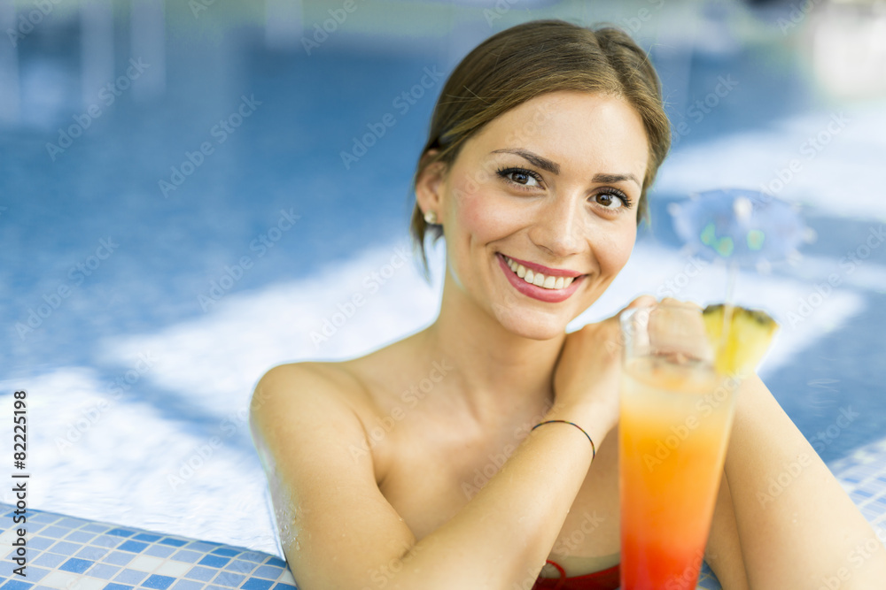 Beautiful woman in a pool with a cocktail Beautiful woman in a pool with a cocktail