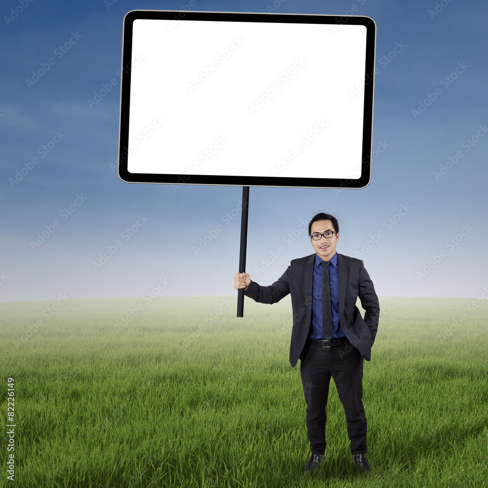Businessman with empty copyspace at field Businessman with empty copyspace at field