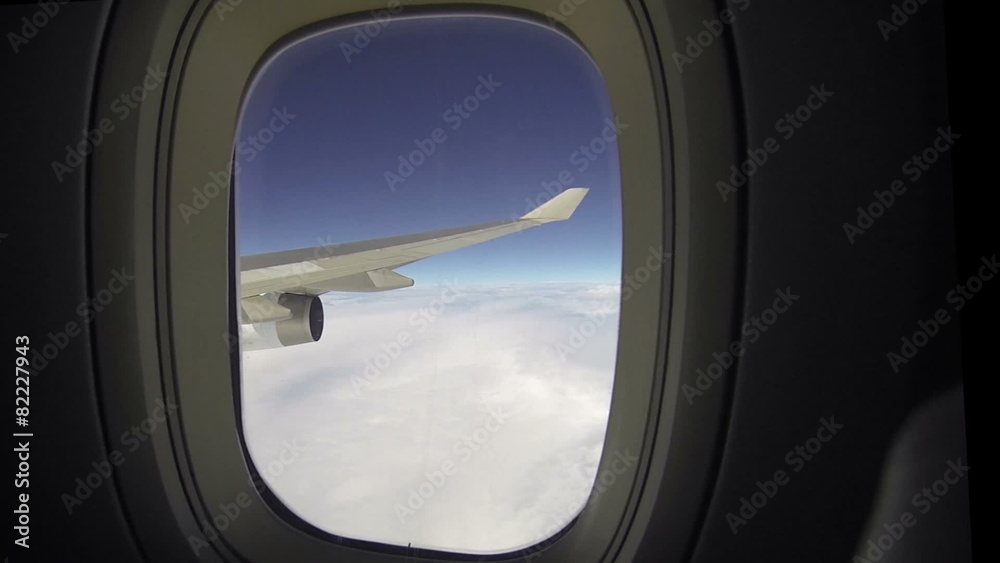 Airplane wing and sky view from window seat Airplane wing and sky view from window seat