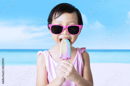 Cute female kid enjoy ice cream