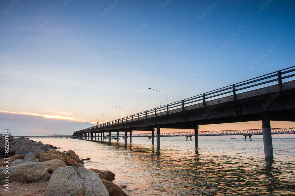 Concrete Bridge over sea water with sunrise